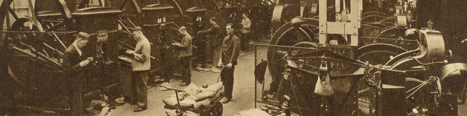 Old black and white photo of coining machines in a Victorian factory