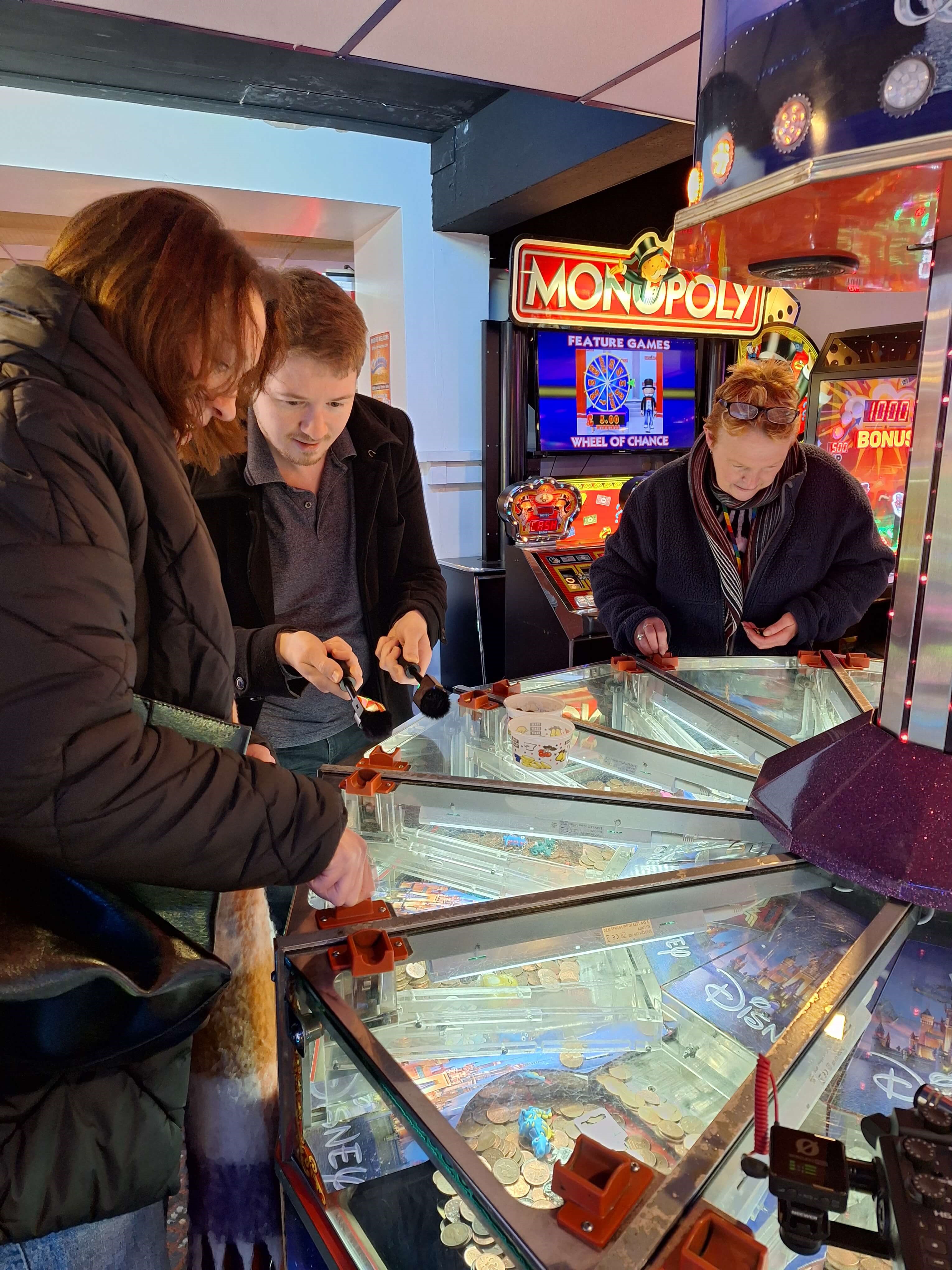 Royal Mint Museum staff playing an arcade game