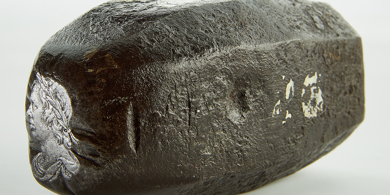 A metal punch with a portrait of Oliver Cromwell made for making coinage dies