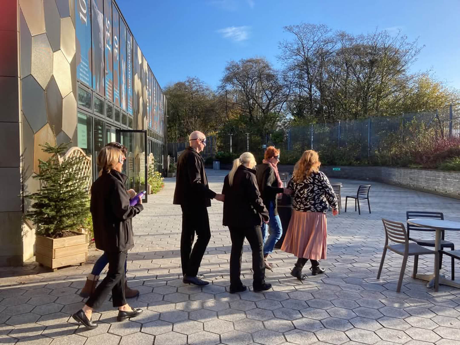 People walking in pairs around the Royal Mint Experience