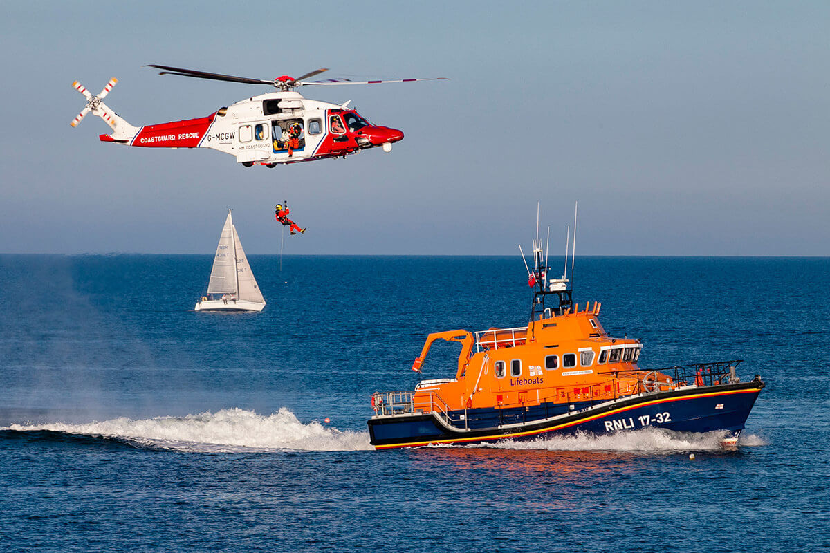 RNLI boat and helicopter crew at sea