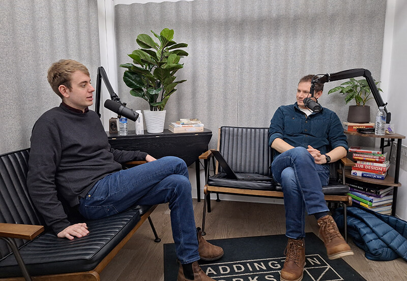 Chris Barker Talking to Dr Daniel Rignall in a podcast studio
