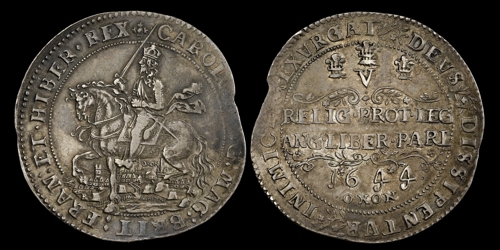 A very large and heavy silver coin. An Oxford crown featuring Charles I on horseback